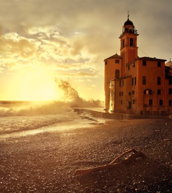 Big waves at sunset on the seafront Camogli clipart
