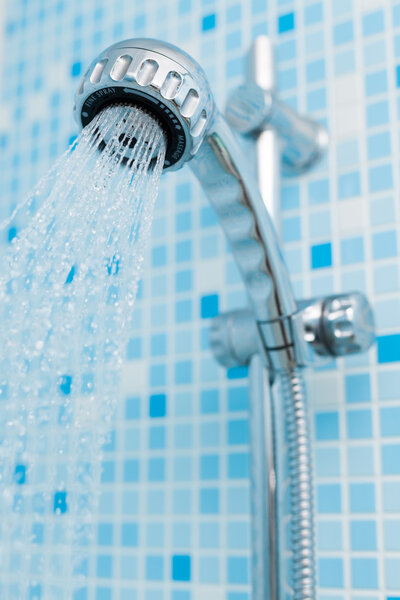 Working head shower on blue background