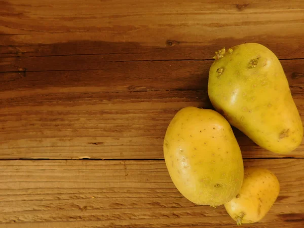 Їдять картоплю на дерев'яній основі — стокове фото