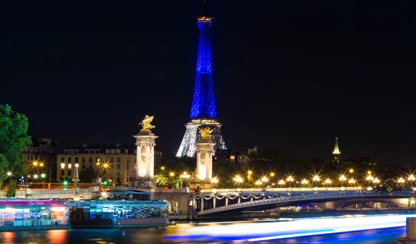 The Eiffel tower lit up with the colors of French national flag. — Stock Photo, Image