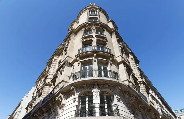 Traditional French house with typical balconies and windows. Paris, France.