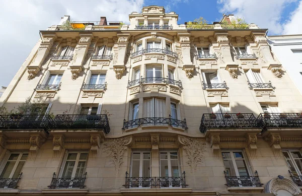 Traditional French house with typical balconies and windows. Paris, France.