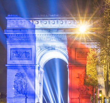 The Triumphal Arch lit up with the colors of French flag.