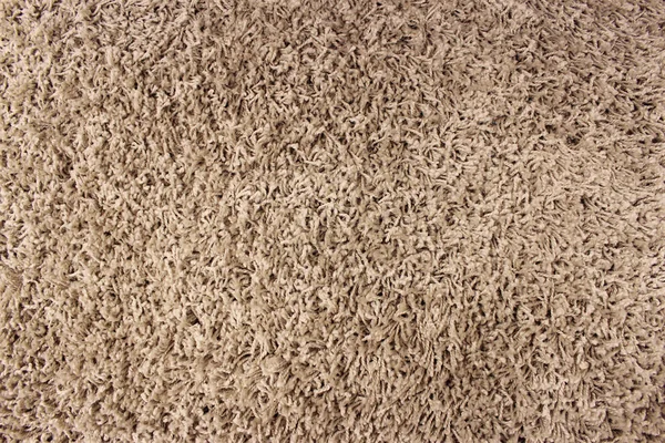 Fragment of material background brown carpet — Stock Photo, Image