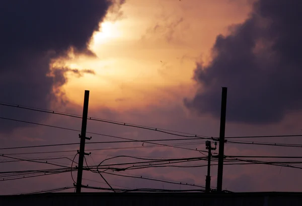 Céu por do sol e fios de cabo no telhado . — Fotografia de Stock