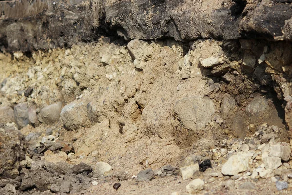 layers in the ground, telling the story of the construction of the road in Gatchina. Visible layer of stone rubble age 250 years - the remains of the royal paving