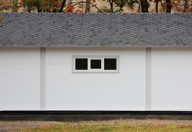 Beyaz duvar desenli ev, kara kutu, arka planda esnek kahverengi fayanslar sonbahar ormanlarının çok renkli yaprakları.