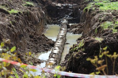 Evin yakınındaki boş bir arazide kırmızı-beyaz uyarı bandıyla çevrili bir acil durum alanı..