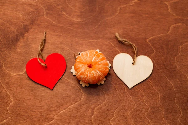 Two Wooden Hearts Mandarine Valentine Day Brown Background — Zdjęcie stockowe