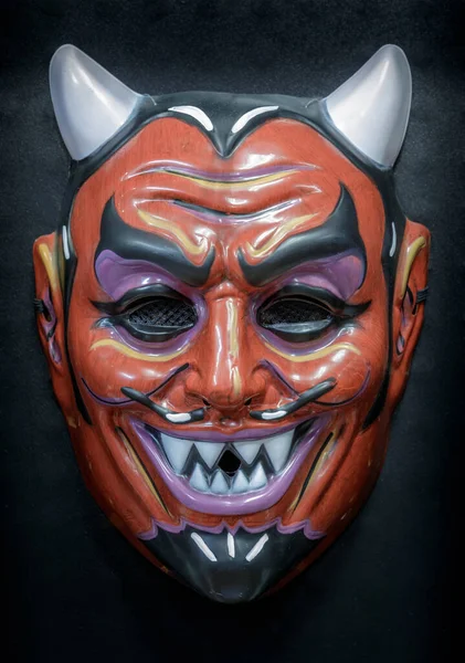 Vintage Devil Face Mask Isolated Against Black Background