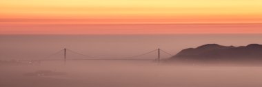 Hazy sunset over Golden Gate Bridge, San Francisco. clipart