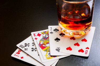 Bardak viski ve iskambil ahşap masa üzerinde siyah bir masa üzerine. Görüş açısı, kimlik kartları