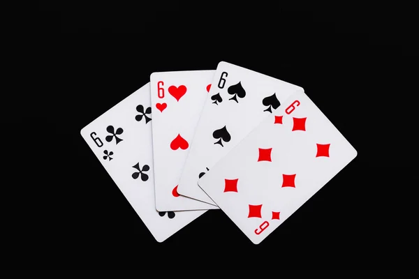 Spielkarten mit vier Sechsen auf schwarzem Hintergrund — Stockfoto