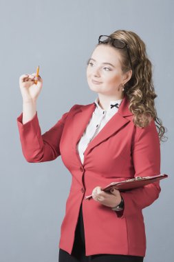 portrait of a beautiful young girl in a red jacket on a gray background with pakoy pencil. Biznes.Arhitektor.Student.