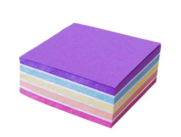 En linjal liggande på en förpackning med färgat papper på ett vitt bord — Stockfoto