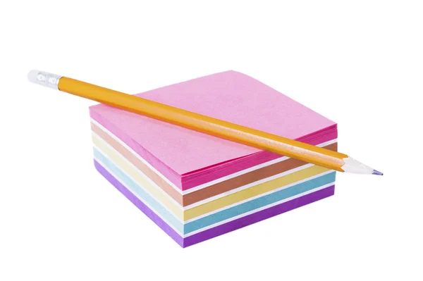 Orange pencil lying on a pack of colored paper on a white background — Stock Photo, Image