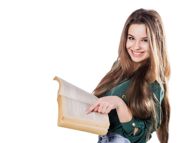 Young girl shows a finger in the book on the isolate. Is reading. Smiles. — Stockfoto
