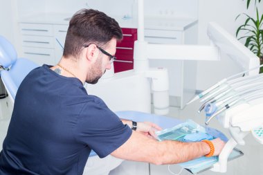 healthcare, profession, stomatology and medicine concept - male  dentist over medical office background