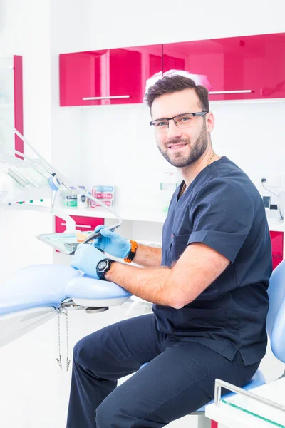 Healthcare, profession, stomatology and medicine concept - smiling male dentist  over medical office background — 스톡 사진