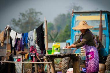 Asian woman washing clothes in Hsipaw clipart