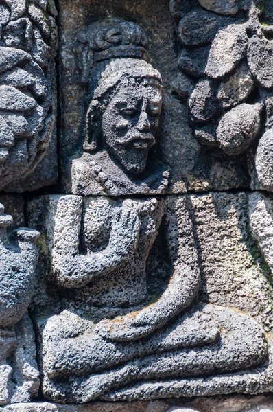 Meditar y sentarse Tallado en piedra en Borobudur — Foto de Stock