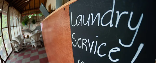 Closeup of Laundry Service sign black board with chalk — Stock Photo, Image