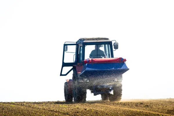 Трактор Распыление поля весной сопровождается — стоковое фото