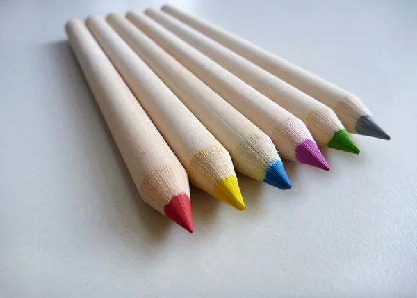 Crayons multicolores sur une table blanche — Photo