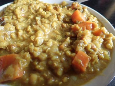 Bir kase sebzeli Hint mercimek çorbası.