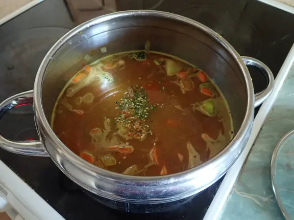fresh homemade  cooking vegetable soup in a pot