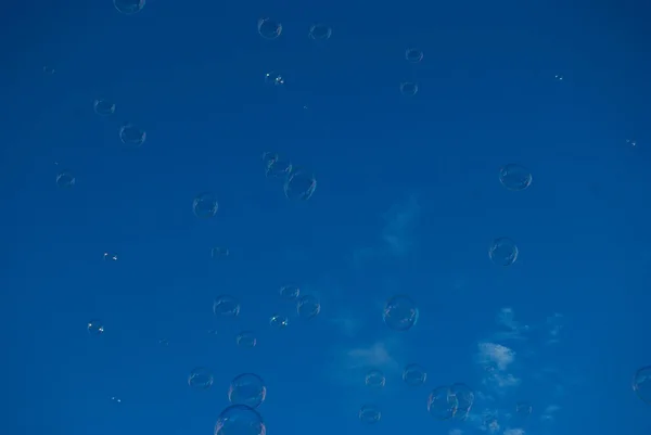 Bubbles flying at the blue sky — Stock Photo, Image