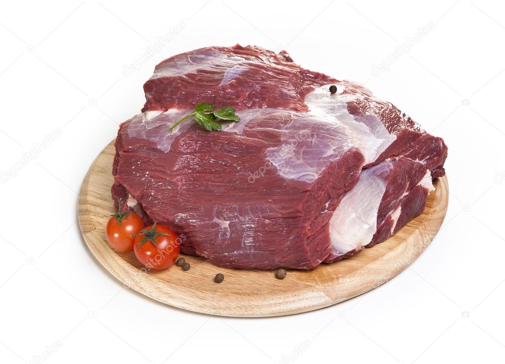 raw beef on the cutting board isolated on the white background.