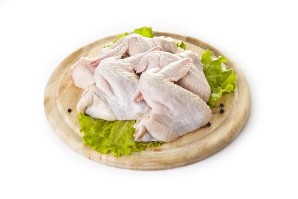 Raw chicken wings on the cutting board isolated on the white Stock Image