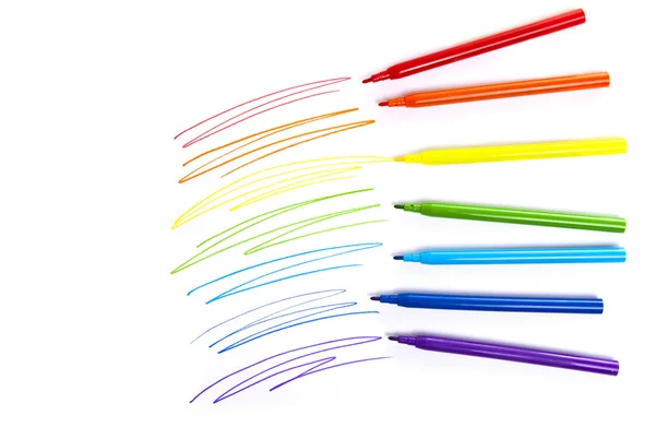 Multicolored markers on a white background top view Stock Picture