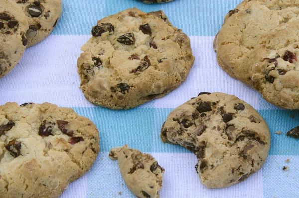 Chocolate cookies on a wooden table. Chocolate chip cookies shot on a blue tablecloth, closeup. — Stock Photo, Image