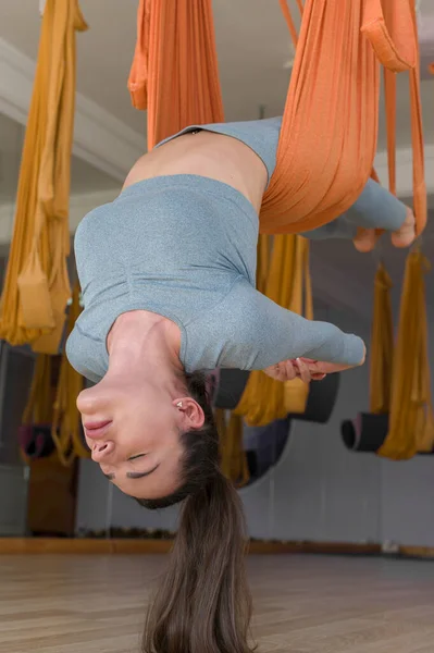 Fly yoga close up sporty woman hanging upside down with closed eyes — Stock Photo, Image