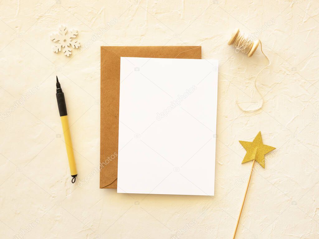 Christmas new year postcard mockup. Copy space for best wishes on a paper sheet with pen. Golden holiday postcard background. Flat lay