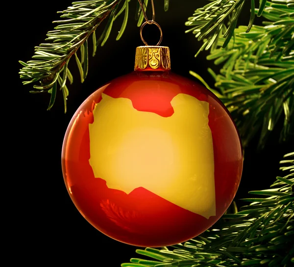Red bauble with the golden shape of Libya hanging on a christmas — 图库照片