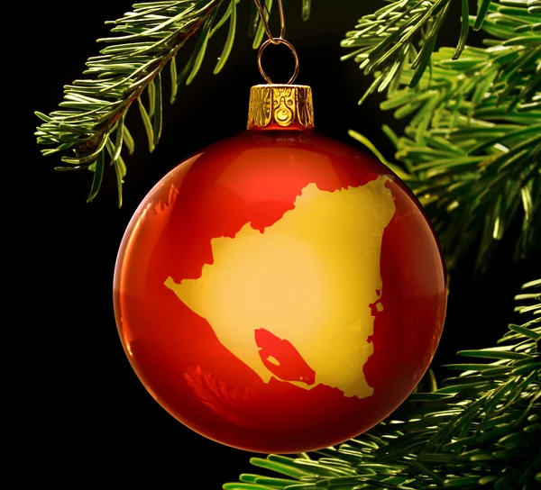 Red bauble with the golden shape of Nicaragua hanging on a chris — 图库照片