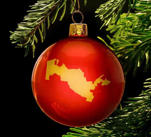 Red bauble with the golden shape of Uzbekistan hanging on a chri — 图库照片