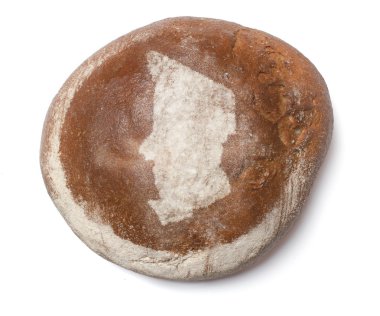 A loaf of fresh bread covered with rye flour in the shape of Cha