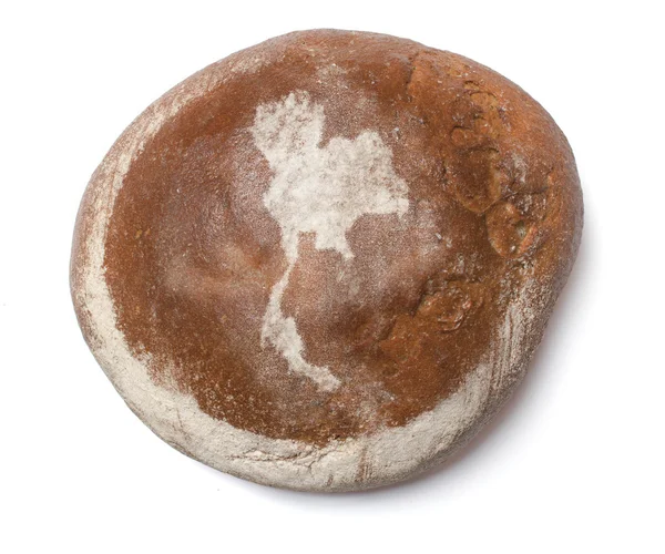 A loaf of fresh bread covered with rye flour in the shape of Tha