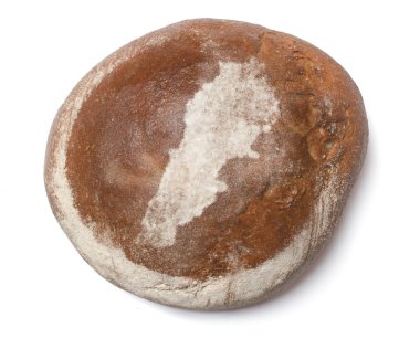 A loaf of fresh bread covered with rye flour in the shape of Leb
