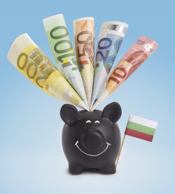 Various european banknotes in a happy piggybank of Bulgaria.(ser