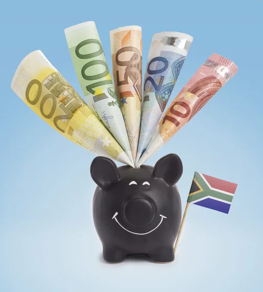Various european banknotes in a happy piggybank of South Africa. — Stock fotografie