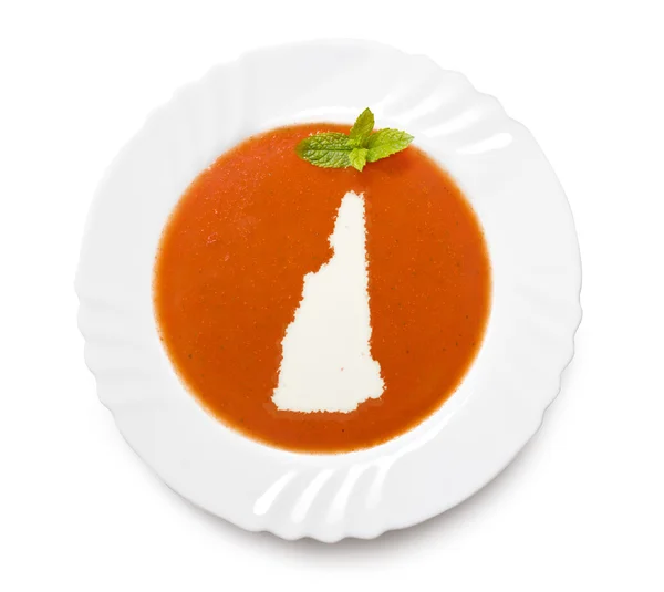 Плита томатный суп со сливками в форме Нью-Гэмпшира. (seri — стоковое фото