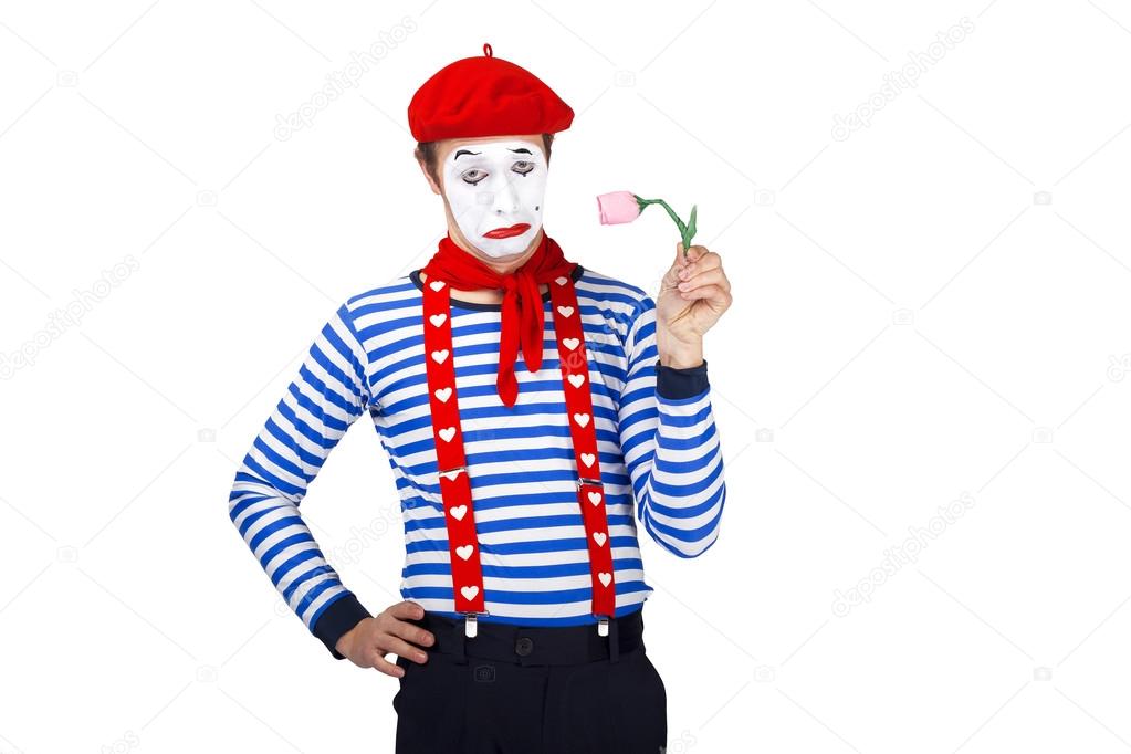 Mime with flower.Emotional funny actor wearing sailor suit, red beret posing on white isolated background.