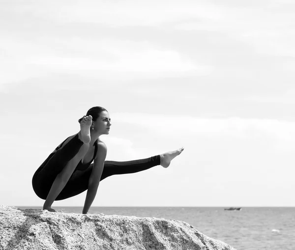 Donna di yoga posa sulla spiaggia vicino al mare e rocce. Isola di Phuket, Thailandia — Foto Stock