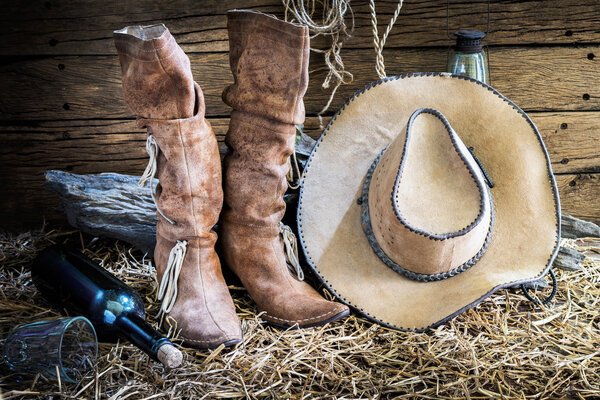 Still life with cowboy hat and traditional leather boots