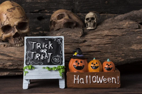 three pumpkins in the box with trick or treat board